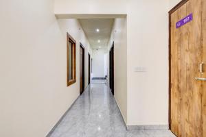 an empty corridor with a wooden door in a building at Hotel O DREAM INN in Alwar