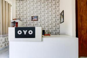 a sign on top of a white counter at Hotel O DREAM INN in Alwar