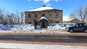 a car parked in front of a building with snow at AparanQ