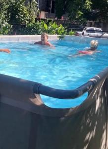 a group of children swimming in a swimming pool at Kobuleti stay inn in Kobuleti