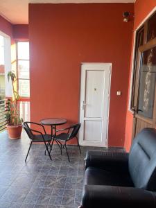 a living room with a table and chairs at Kobuleti stay inn in Kobuleti