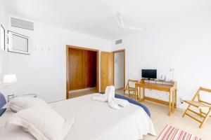 a bedroom with a bed with a towel on it at Biniancolla Heura in Biniancolla +41 photos