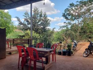 a table and chairs on a patio with a motorcycle at Srey leaphome stay & trekking in Banlung