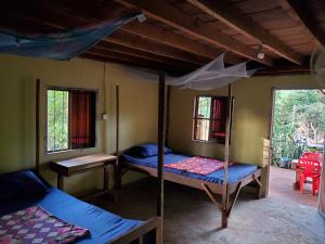 a room with two bunk beds and two windows at Srey leaphome stay & trekking in Banlung