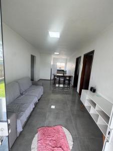 a living room with a couch and a table at Casa nova em Torres in Torres