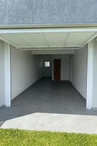 an empty garage with a door in a building at Casa nova em Torres in Torres