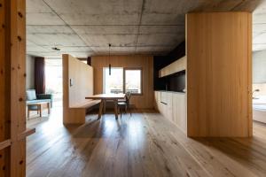 a kitchen and dining room with a table and cabinets at Füchslhof in Marlengo