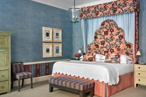 a bedroom with a large bed with a canopy at Haymarket Hotel, Firmdale Hotels in London