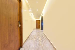 a hallway with a tile floor and a long corridor at FabHotel Aishwarya in Kota