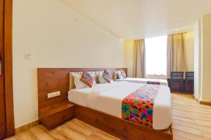 a bedroom with a large bed in a room at FabHotel Aishwarya in Kota +27 photos