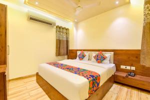 a bedroom with a large white bed in a room at FabHotel Aishwarya in Kota