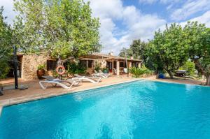 a swimming pool with chairs and a house at YourHouse Padri de Inca in Inca