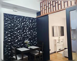 a dining room with a black and white wall at Paseo Verde Condo Unit in Las Pinas - Sleeps 2 Adults & 2 Children in Manila