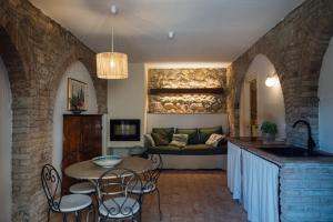 a living room with a table and a couch at Fattoria San Donato in San Gimignano