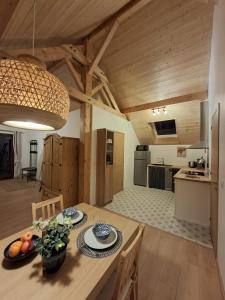 a kitchen and dining room with a wooden table and chairs at Chalet du Mont Granier in Apremont