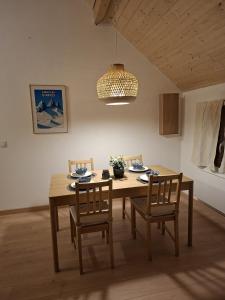 a dining room with a wooden table and chairs at Chalet du Mont Granier in Apremont +17 photos