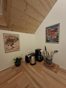 a kitchen counter with pots and pans on a wooden floor at Chalet du Mont Granier in Apremont