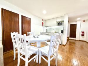 a white dining room table and chairs in a kitchen at Casa do Castello Chaves in Chaves