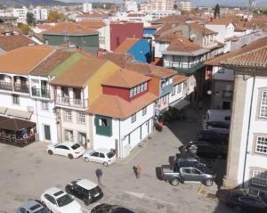 a city with cars parked in a parking lot at Casa do Castello Chaves in Chaves