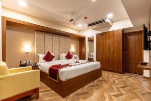 a hotel room with a bed and a chair at HOTEL BLUEMOON in Tirunelveli +102 photos