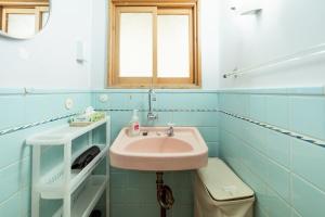 a bathroom with a sink and a toilet at Denim Lodge Nest in Kurashiki +18 photos