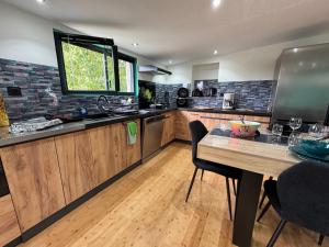 a kitchen with a table with chairs and a window at Panorama in Seigy