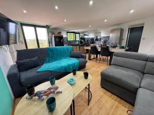 a living room with a couch and a table at Panorama in Seigy