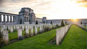 an old cemetery with a fence in front of a building at La Maison du Souvenir in Beaucourt-sur-lʼAncre