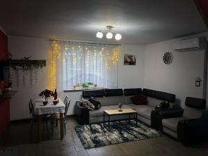 a living room with a couch and a table at Lazurowy Zakątek in Życiny