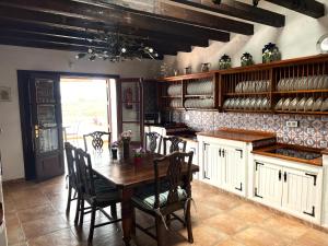 a kitchen with a wooden table and chairs at Casa Tara - 5 bedroom, 4 bathroom villa with private pool in Mácher