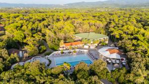 an aerial view of a mansion with a pool and trees at Paradù EcoVillage & Resort in Marina di Castagneto Carducci