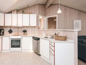 a kitchen with white cabinets and a sink at 8 person holiday home in Børkop in Børkop