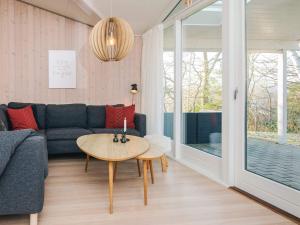 a living room with a couch and a table at 8 person holiday home in Børkop in Børkop +29 photos