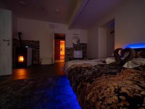 a bedroom with a bed with a blue light at Hideaway in Ostrava