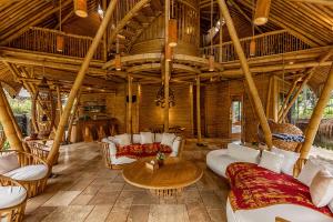 a large living room with white furniture and a wooden ceiling at Cacao House 4bds Eco Bamboo House, pool, near Green School Bali in Bringkit