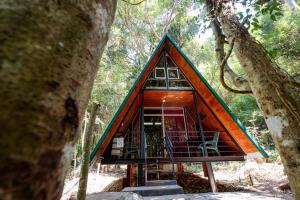 a tree house in the middle of a forest at Sandungira Eco Resort in Belihuloya