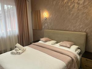 a bedroom with a bed with two stuffed animals on it at Vila Mery in Moisei