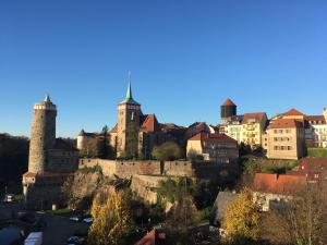 a view of a city with towers and buildings at MOMENTS Boutique Hotel in Bautzen