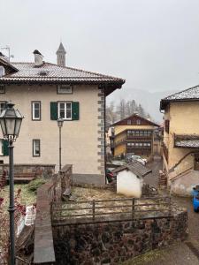 a house and a street light in a village at Ca' Stella in Castello di Fiemme