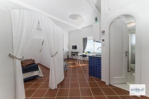 a hallway with a room with a bathroom and a kitchen at La Suite 48 in Vietri sul Mare