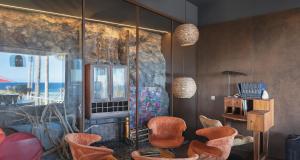 a living room with orange chairs and a window at Smart Elegant Villa with Amazing Tropical Views in Toiny