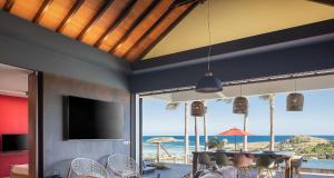 a dining room with a view of the ocean at Smart Elegant Villa with Amazing Tropical Views in Toiny +12 photos