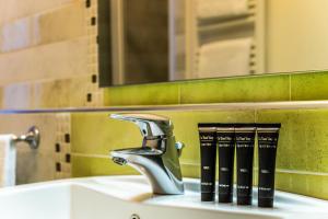 ein Waschbecken im Badezimmer mit Wasserhahn und Büchern darauf in der Unterkunft Cà Sant`Angelo in Venedig + 66 Fotos
