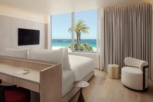 a hotel room with a bed and a view of the ocean at Morea House, Autograph Collection in Cape Town