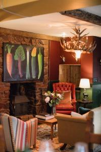a living room with a couch and a fireplace at The White Hart in Wiveliscombe