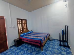 a bedroom with a bed and a blue floor at Vino lanka in Trincomalee