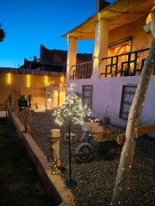 a house with a christmas tree in front of a house at CHÂTELET Ouarzazate in Tabount