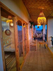 a hallway with a room with a table and chairs at CHÂTELET Ouarzazate in Tabount
