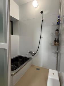 a white bathroom with a sink and a toilet at サウスウインズ in Kagebai +10 photos