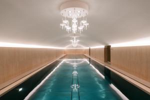 a swimming pool with a chandelier in a building at Hotel Sans Souci, Vienna in Vienna
